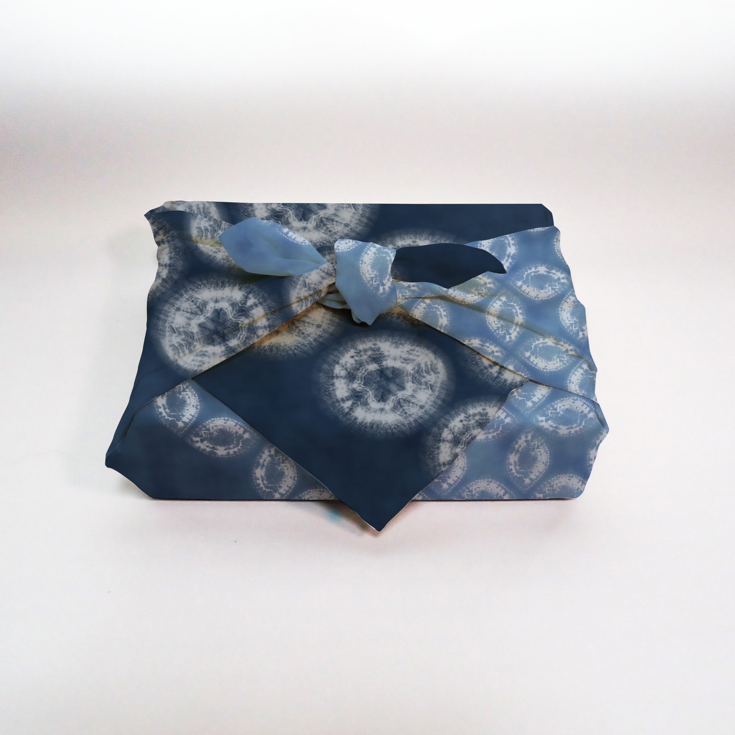 Furoshiki mockup showing patterned fabric wrapped in traditional style